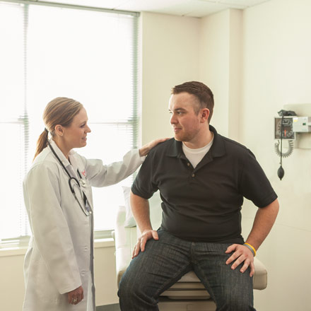 Doctor visiting with patient.