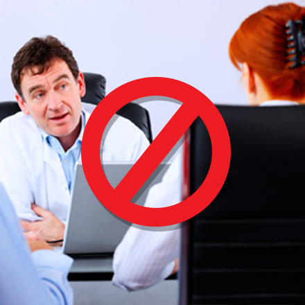 Stocking image of a doctor behind a computer talking to a patient that is crossed out.